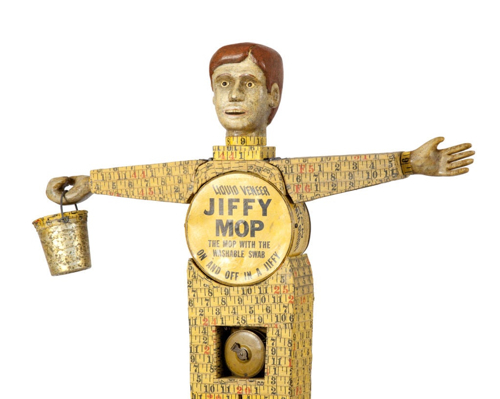 Jiffy Mop Man<br />
By Harvey Peterson<br />
2008<br />
Wood assemblage of jiffy tin, tape measures, mop head<br />
and bucket.