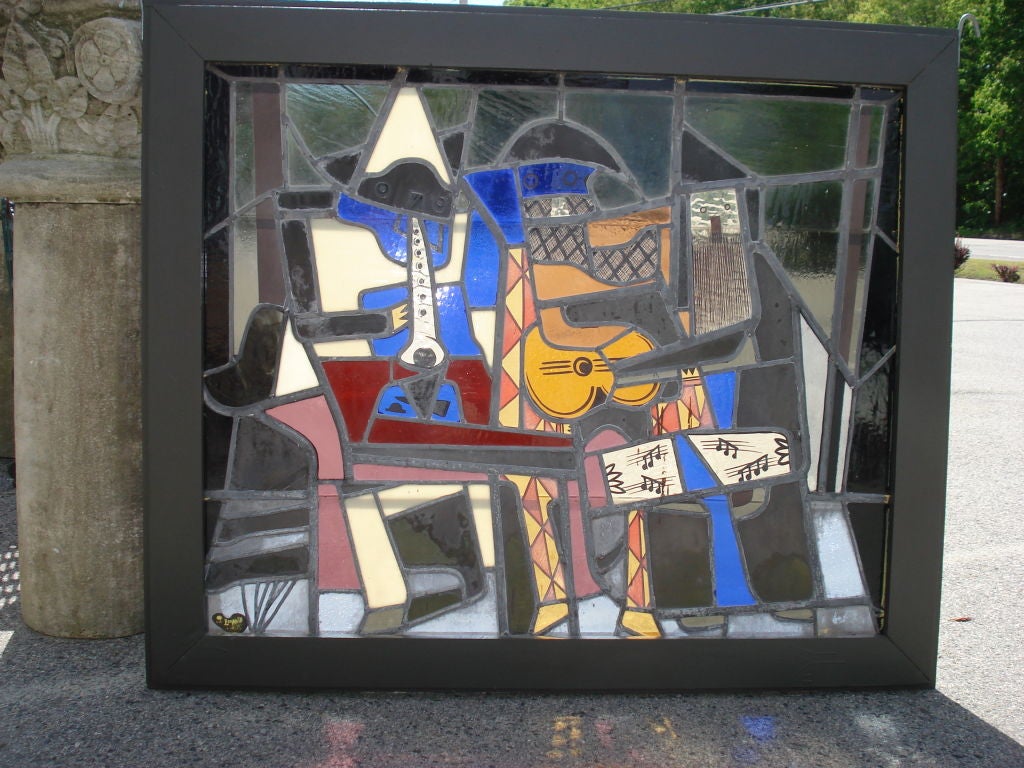 SIGNED AND DATED STAINED GLASS WINDOW DEPICTING PABLO PICASSO'S THE THREE MUSICIANS. SIGNED IN LOWERLEFT WITH A PALETTE SHAPE WITH L.Y.LEOPOLD 1961. NEW WOOD FRAME