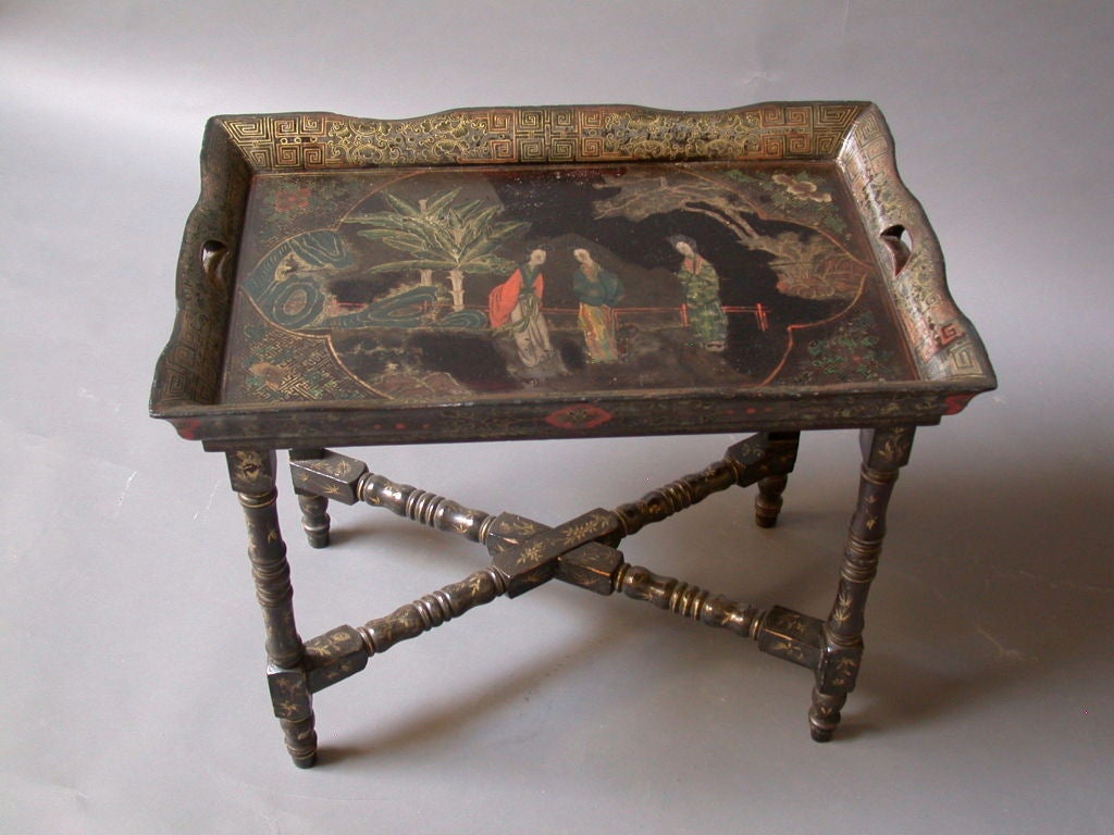 Small 19th Century Chinese Export Tray Table.  Black lacquer tray with canted sides on the  original base with turned legs and stretchers.   Intricate polychrome and gilt chinoiserie decoration throughout. Canton circa 1880.