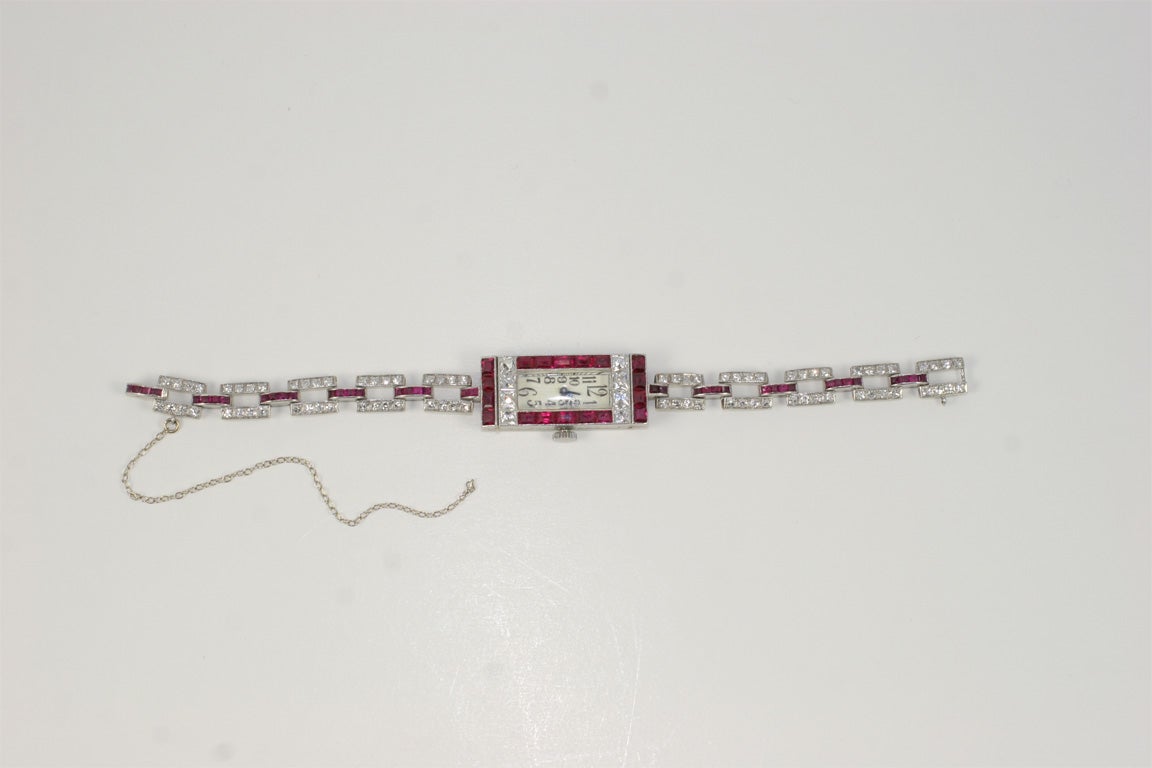 A platinum watch containing 80 round diamonds, 8 French Cut diamonds weighing, appox. 2.75 cts, and 54 baguette cut rubies, appox. 2.75 cts.<br />
<br />
Color: G<br />
Clarity: VS