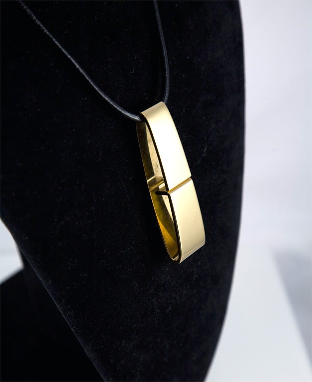 Great Gucci pendant, one of the best designs from the Tom Ford years.  Sterling Silver with a gold wash, hanging on black leather cord with gold washed silver closer. (This has been married to the pendant)  Pendant is fully marked.