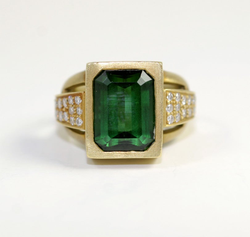 18kt Matte Yellow Gold Ring set with Flawless Emerald Cut Intense Color Green Tourmaline with Graduated Diamond Sides. Signed 