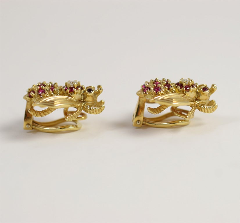 Pair of 18kt. Yellow Gold clip on earings in the form of a Bee and set with Rubies & Diamonds.  Each earing set with 18 Rubies & 1 Diamond. Marked 750 & c Tiffany & Co. Wings are ridged to add detail.