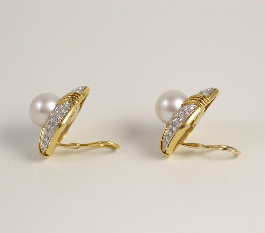 Magnificent Pair of 18kt Yellow & White Gold Earings, each set with a South Sea Pearl measuring 13mm and Pave set with 48 very clean & very white full cut Diamonds set in White Gold. Total Diamond Weight: Approx. 9cts. Ca. 1980. The Earings are