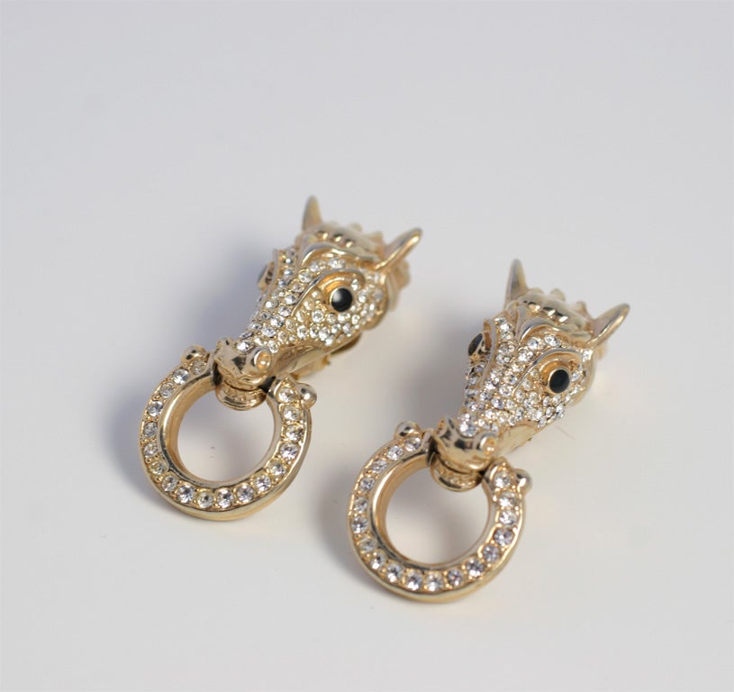 Rhinestone encrusted horse head earrings.