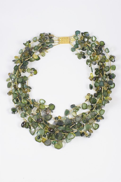 A one of a kind five strand green tourmaline wreath necklace. Each tourmaline sliver is separated by an 18kt yellow gold bar.