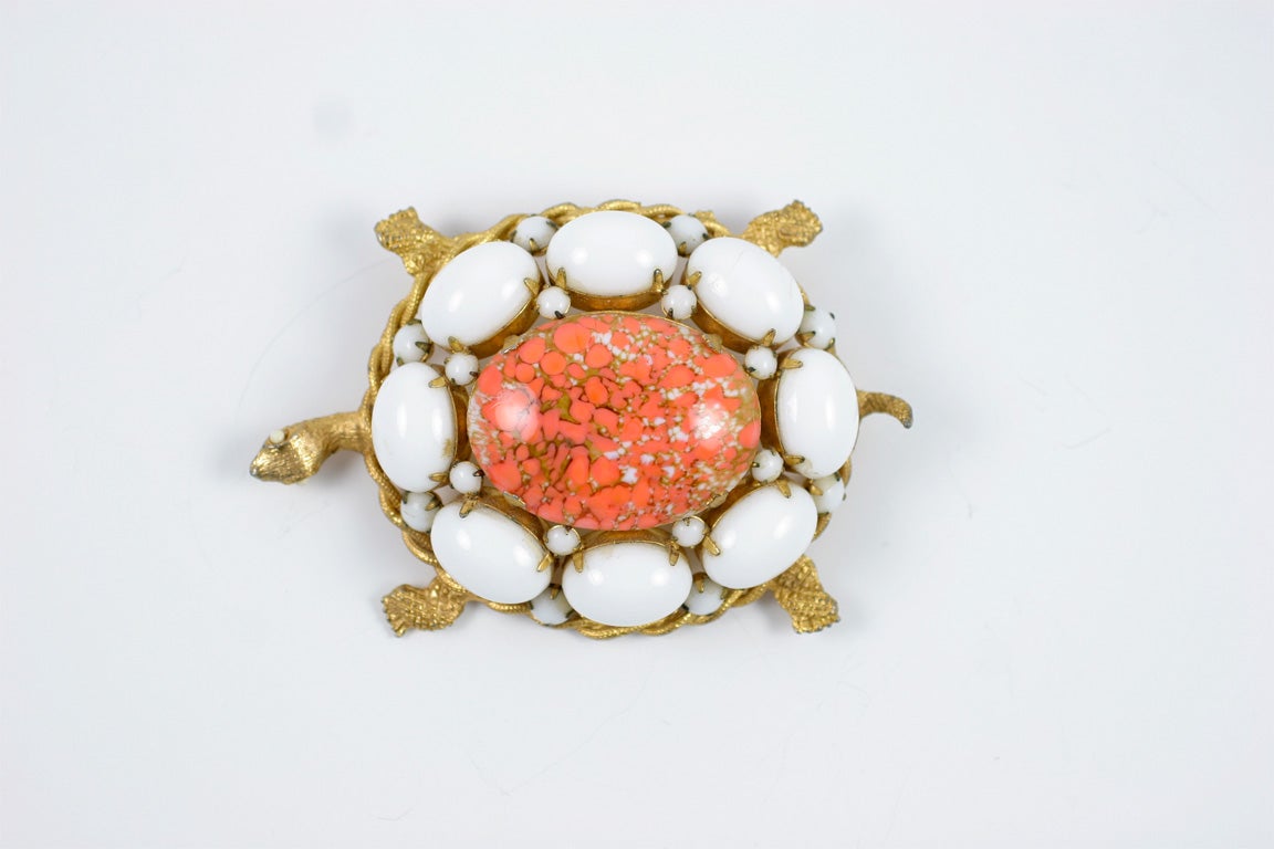 Large turtle brooch with white prong set cabochon stones and a large oval, mottled orange cabochon center stone. Nicely detailed DeNicola piece.