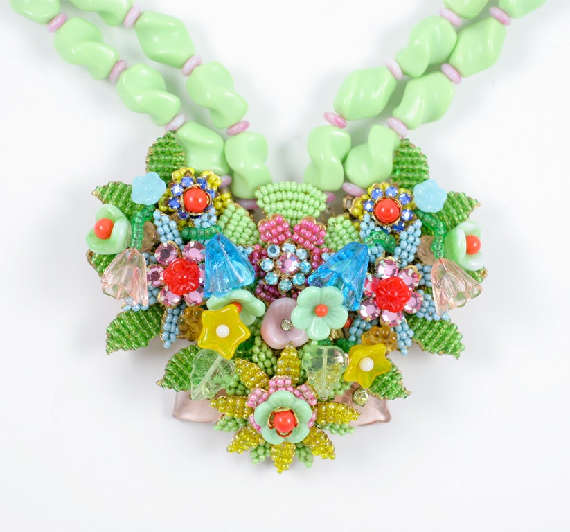 Stunning celadon green beaded necklace with a multicolored floral cluster. Floral cluster is 4