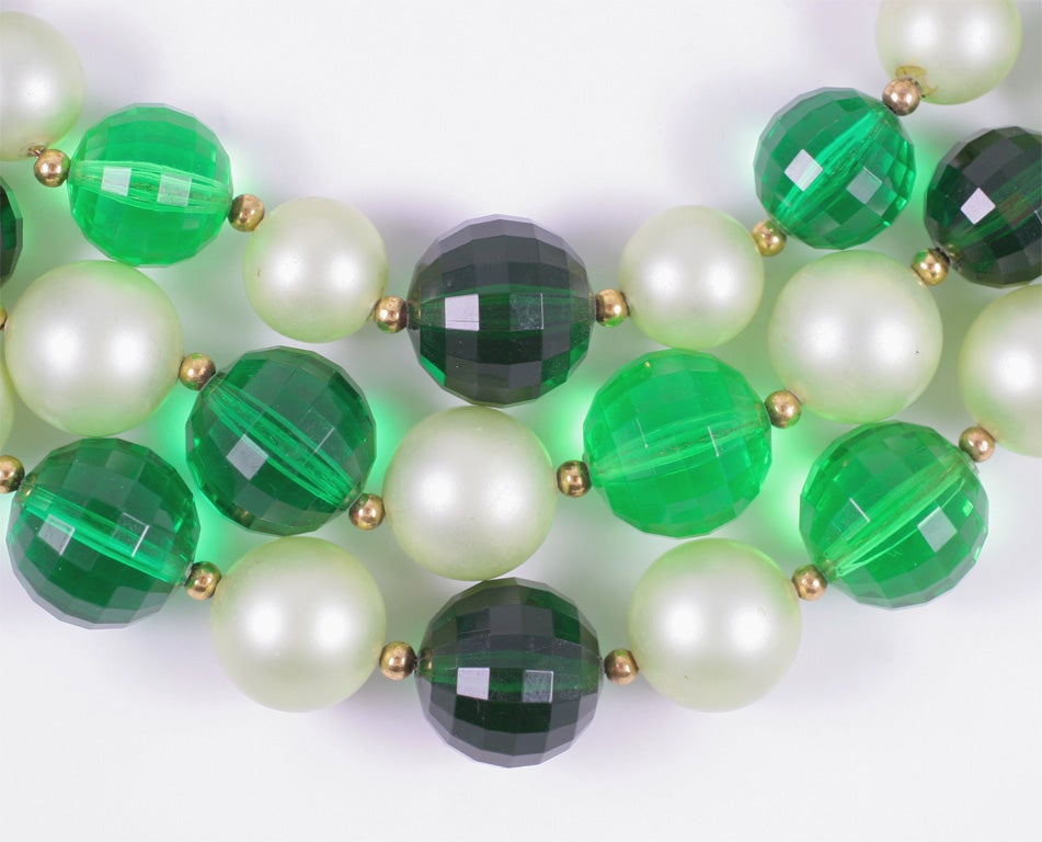Three strand necklace with graduated and alternating green faceted lucite beads and 