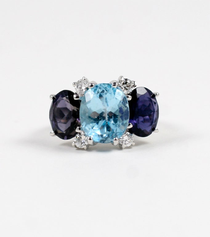 Medium 18kt white gold Gum Drop ring with blue topaz (approximately 5 cts), iolite (approximately 4 cts each), and 4 diamonds weighing 0.48 cts.

Specifications: Length: 7/8