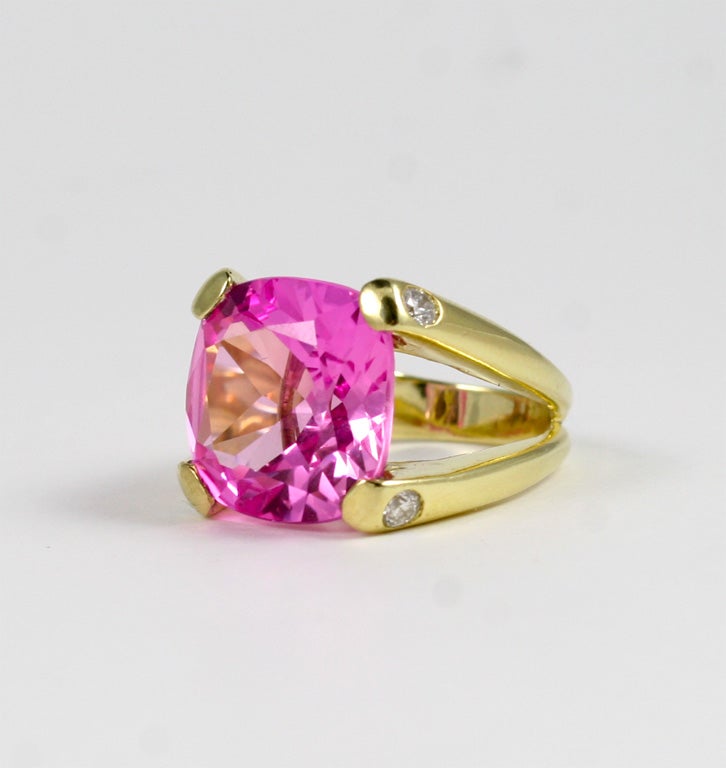 18kt Yellow Gold split shank dome ring with center Cushion Cut Pink Topaz (approximately 25cts) and four diamonds(approximately 0.40cts).  Sized to order.

The Cushion Ring collection is available in any stone combinations in either yellow gold or