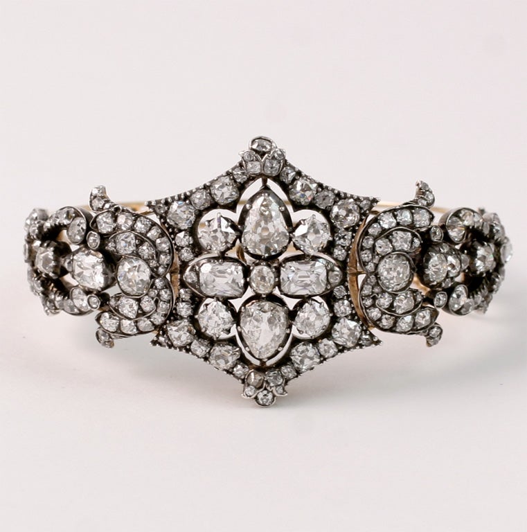 A woman can easily feel like a Queen when wearing this piece of jewelry. The three central elements of this bracelet can be removed and attached to a separate head piece to form a regal tiara. The fine European cut diamonds, set in silver as typical