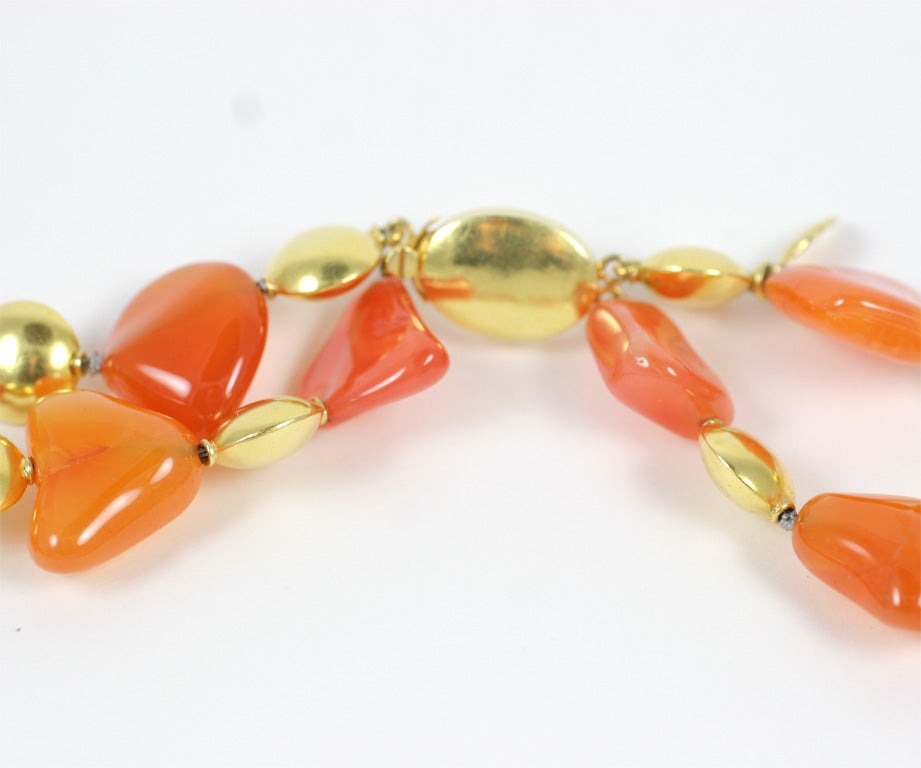 A Carnelian and 18kt yellow gold cloud necklace. The Carnelian beads were hand carved in Idar Oberstein and are separated by 18kt yellow gold smartie beads.

*** This necklace was recently restrung into a single strand with no clasp. It is