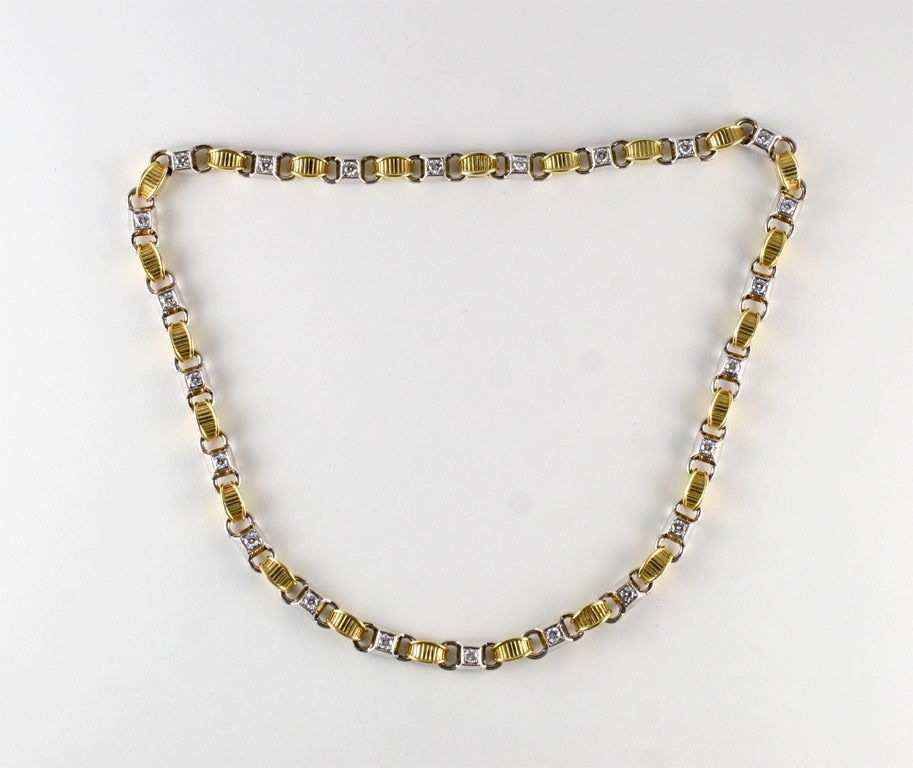 Segmented necklace with 18kt Yellow Gold elements & White Gold raised sections, each set with a 10 point full cut Diamond. Can be separated to a bracelet.  Marked 750, DKW, & numbered 8832.  Total of 23 Diamonds & weighing 34.8 dwt.