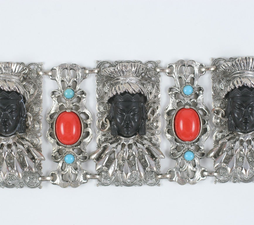 Wide linked bracelet with three African princess faces and red and turquoise cabochons. 7.25