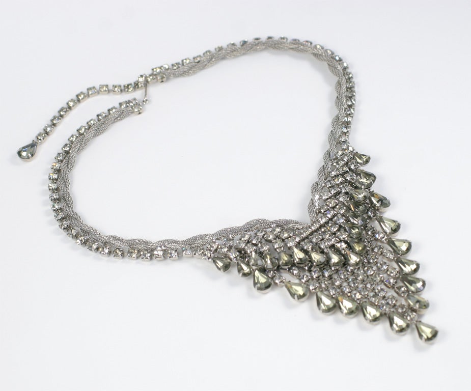 Prong set rhinestones attached to a twisted metal mesh rope necklace with matching earrings.  Minimum length is 15 1/2