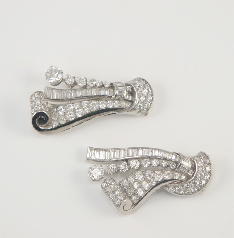 Platinum scroll wowrk clips set with round anad baguette diamondstotal weight 11.50 carats