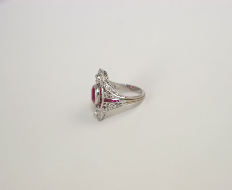 18k White Gold Diamond and Ruby Dinner Ring<br />
oval center ruby 1.23 carats<br />
2 diamonds 0.30 carat<br />
38 diamonds 0.50 carat