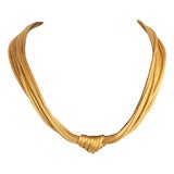 A draperie gold necklace .