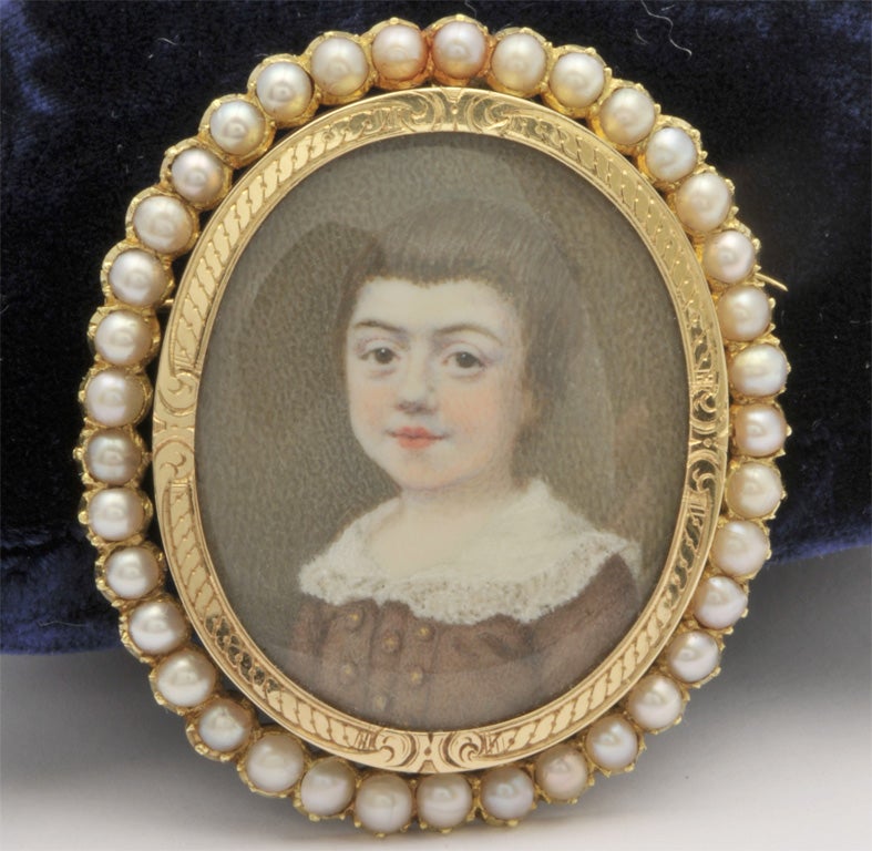 An 18 carat gold brooch set with natural pearls and a beautiful Boy portrait painted on ivory