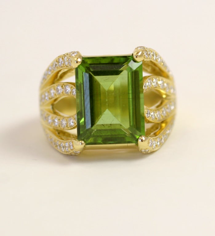 18k Yellow gold ring centering an Emerald Cut  Peridot 9.55 carats      set with 92 full cut diamonds 1.20 carats