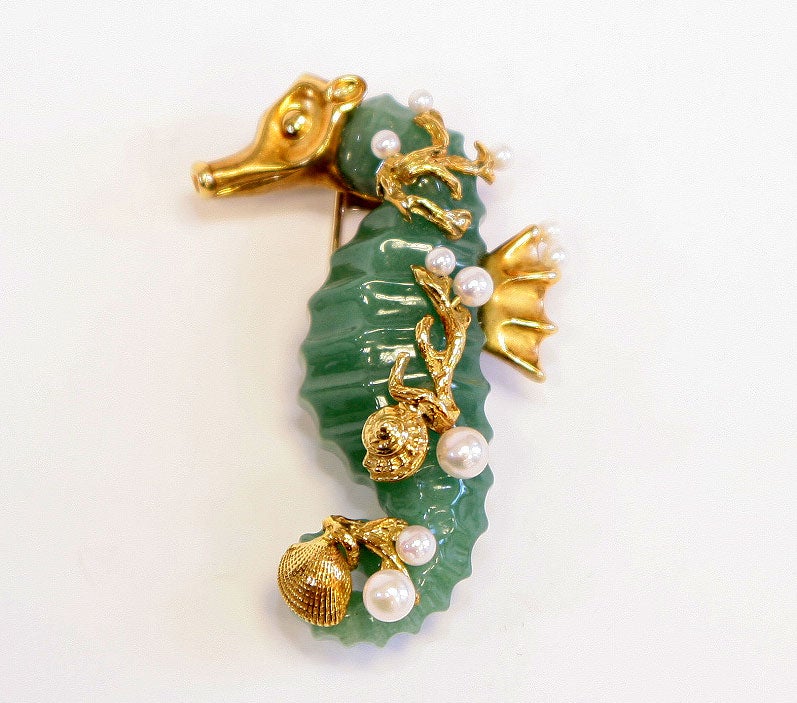 Whimsical carved adventurine body with the head tail and dorsal fin applied in 18k yellow gold.