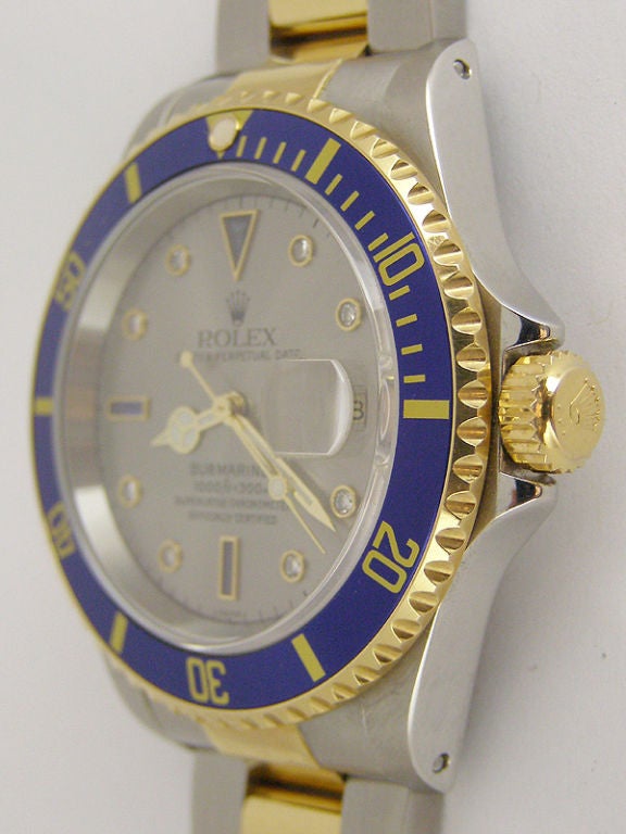 Rolex SS/18K YG Submariner ref #16613 A5 serial # circa 2001 in super minty condition with factory gray serti dial set with sapphire baguettes at 6 9 and 12 and 8 round diamond indexes. Unidirectional blue elapsed time bezel with gold printing. Self