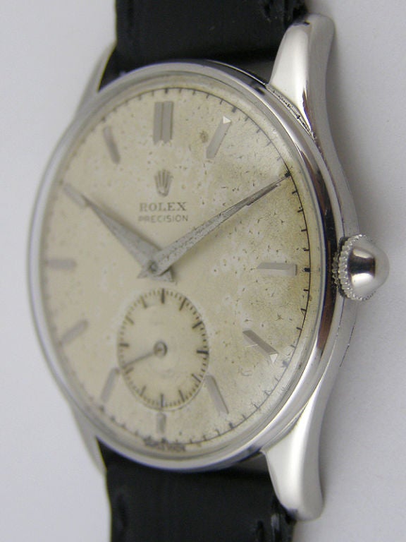 Rolex SS dress model 32 x 39 mm case circa 1950's with original patina'd silver dial with applied silver indexes and tapered dauphine hands. 17 jewel manual wind movement with subsidiary seconds. Original mushroom style crown, clean caseback without
