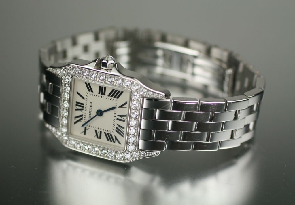 Cartier Santos Demoiselle 18k white gold with diamonds. This is on a 18k white gold Cartier bracelet with deployant clasp. Comes with original box and papers.