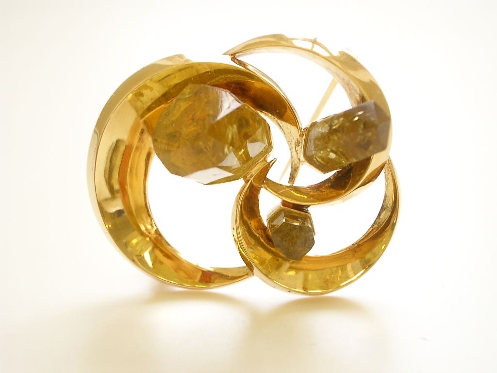A sculptural yellow gold and beryl brooch. The three natural crystal cylinders enhanced by faceting rise boldly from a polished stylized trefoil brooch. Dutch, hallmarks. Purchased in Amsterdam,Unique.