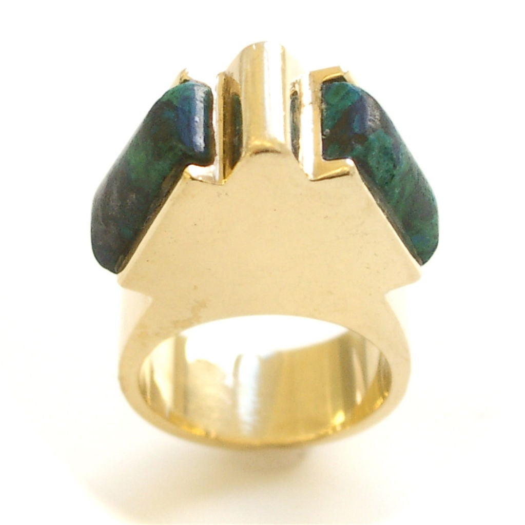A 70's modernist 14k yellow gold and azure malachite* ring. The polished gold shank in the shape of a stylized pyramid,inset with a pair of azure malachite lozenges. The