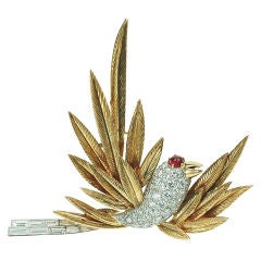 A diamond and gold bird brooch by Cartier