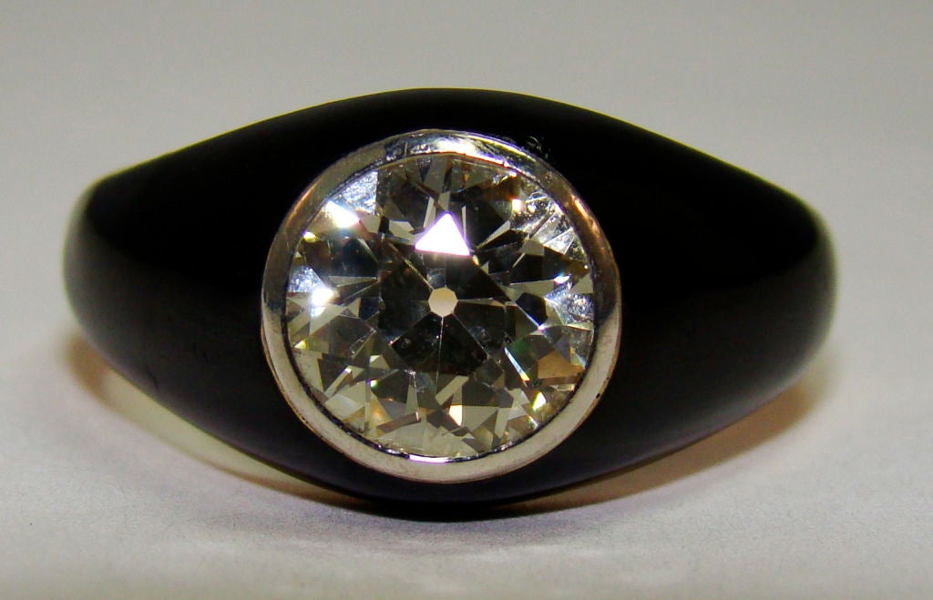 Gypsy setting became popular in the late 1880's, marked by the mounting created flush with the top of the bezel set Diamond. This ring is rare with black enamel baked onto 18k Yellow Gold. The old European cut Diamond weighs 1.87 carats, K color VS1