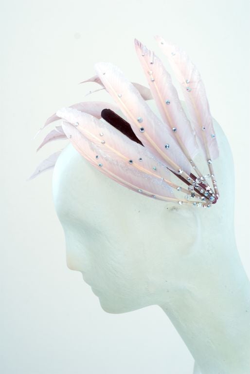 From the Master of the whimsical hat, comes a well, whimsical feathered head band with diamanté applied to the feathers.  Perfect for when you are feeling a little madcap heiress!
