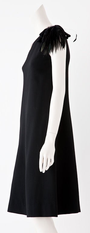 Chanel Black wool crepe one shoulder dress with Egret feather detail at shoulder. This dress was made in the late 60's before the existence of the 