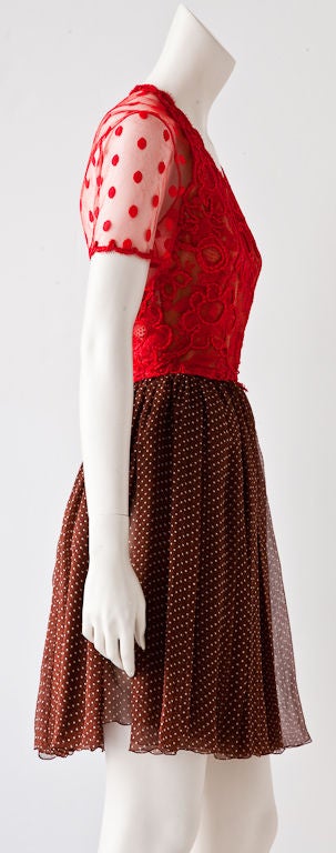 Wonderfully odd combination of a bodice of red guipure and point d'espirt lace and panels of double layered brown and tiny white polka dot chiffon skirt. Front bodice is lined in a nude georgette.<br />
Sleeves and back are sheer point d'esprit