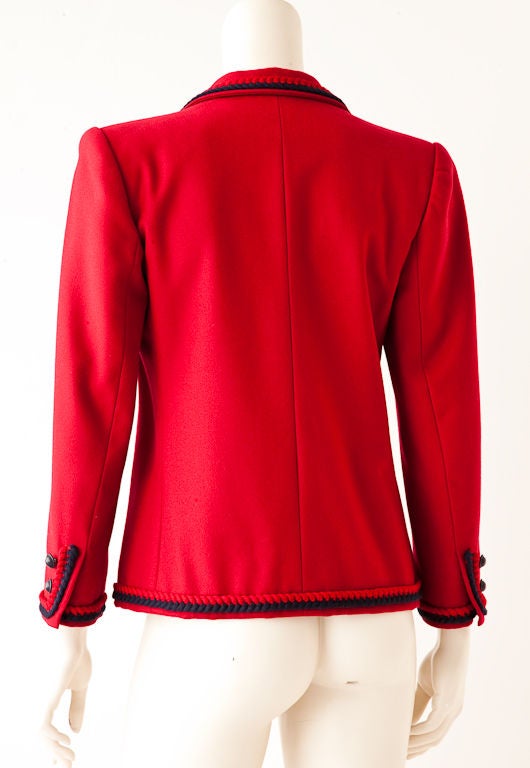 YSL red wool iconic masculine shaped jacket with red + navy wool<br />
braided trim along collar,  lapels , hem and cuffs of sleeve.. Slightly shaped waist with breast and front pockets.