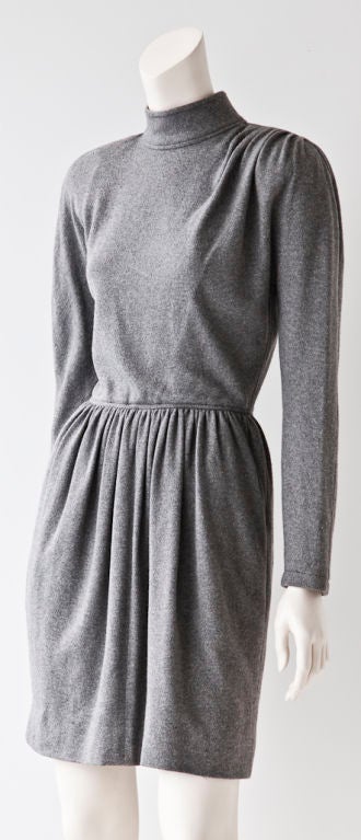 Oscar de la Renta gray cashmere knit long sleeved day dress with mock turtle neck and long sleeve.  Draping detail at shoulder is so today.