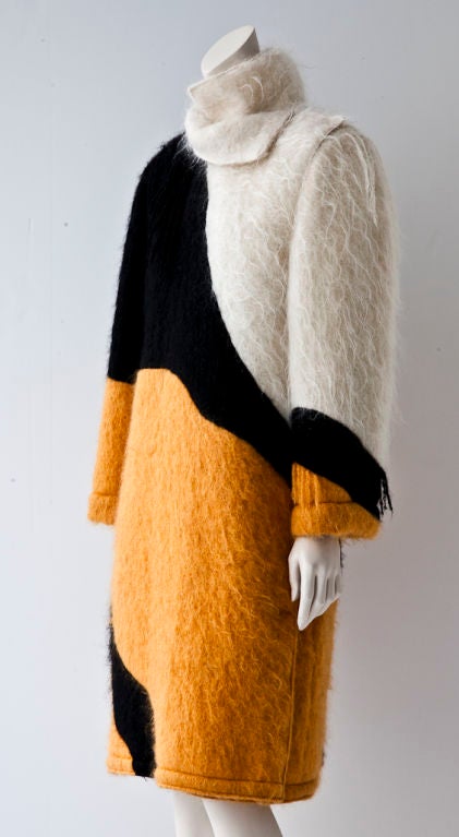 Castelbajac mohair, side, closure coat with blocks of colors in Ochre, Ivory and Black creating a dramatic graphic pattern.There are whimsical tufts of fringed mohair pieces randomly placed at the shoulder, sleeve and body of the coat. Interior is