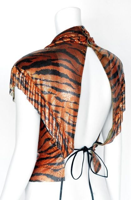 Eye Catcher! You will be sure to get spotted in this fantastic piece.<br />
<br />
This great Ferrara top has a open back and a very sexy cowl neck line.<br />
There is a snap closer at the neck and leather tie at the waist line. <br />
The mesh