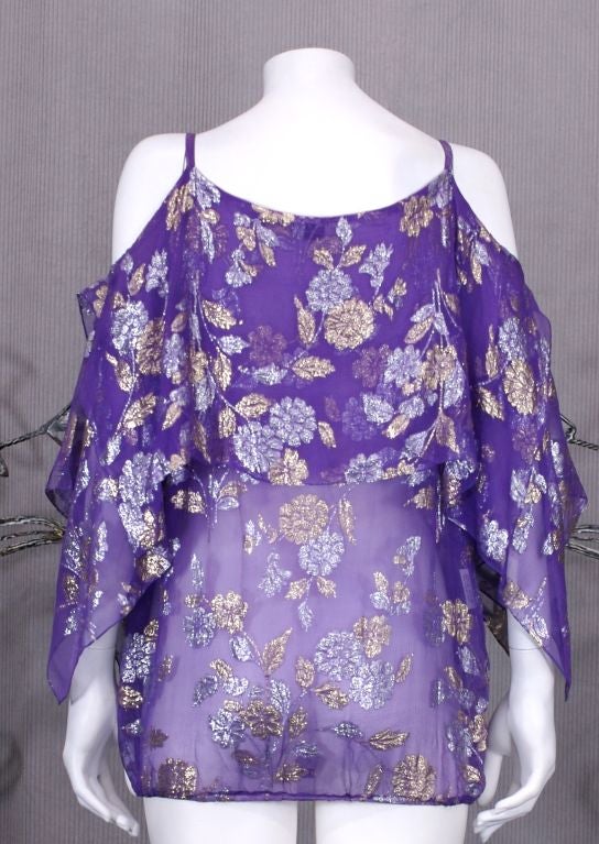 Sexy Julio silk chiffon floral evening blouse in gold,silver lame on a purple ground. Handkerchief points hang from shoulder. Elasticized blouson waist. Length: 25", 1980's USA. 
Excellent condition. 