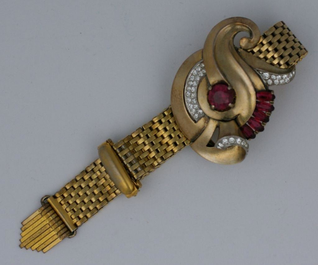 Kreisler retro motif slide bracelet. Faux ruby and pave swirl motif on flex mesh chain ending in metal fringe. Adjustable for all sizes.<br />
Length: total 8.25