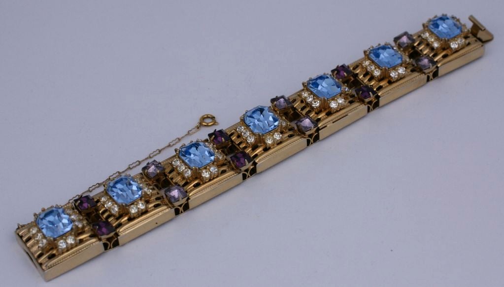 Unusual pierced metal station bracelet set with amythest and aqua crystals. Chunky flexible link with safety chain.<br />
Length: 7.5
