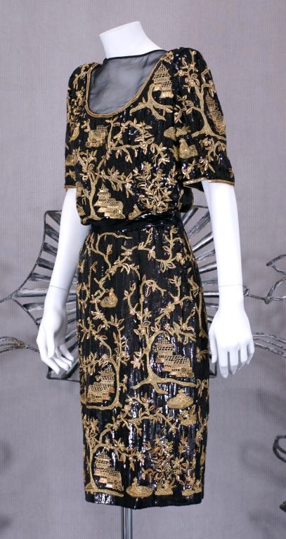 Luxurious and elegant 2 pc Valentino cocktail dress. The T shirt top and skirt are completely embroidered with gold sequins,boullion, seed beads and crystals on a black microsequin ground. Patterns are based 19th C. chinese coromandel screens.<br