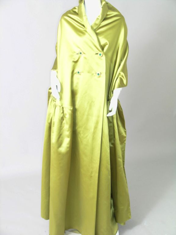 What an amazing piece from Hattie Carnegie Original!  The trompe l'oeil design is so clever, the appearance of an evening coat from the front and an evening wrap from the back. The color choice is pretty amazing as well, rich, deep olive green in a