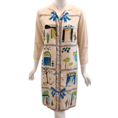 This is a collective silk dress or shirt by BERNARDO. The print on the garment is attributed to some of the most memorable designers of our time, Christian Dior, Chanel, Cardin, Balenciaga, Jacques Fath, Balmain, and Givenchy. It has nine buttons