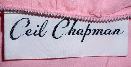 This is a vintage pink chiffon cocktail dress by Ceil Chapman, from the 1960's. The dress has short sleeves with a beautifully pin tucked draped side boned  bodice and a flowing chiffon skirt. Hidden back metal zipper with a hook and eye at the