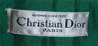 This is a green vintage wool jacket by Christian Dior Haute Couture, from 1973. The jacket has a detatchable genuine peacock collar, green silk lining, two open front pockets, a manderine collar, and four green buttons up the front.<br />
<br