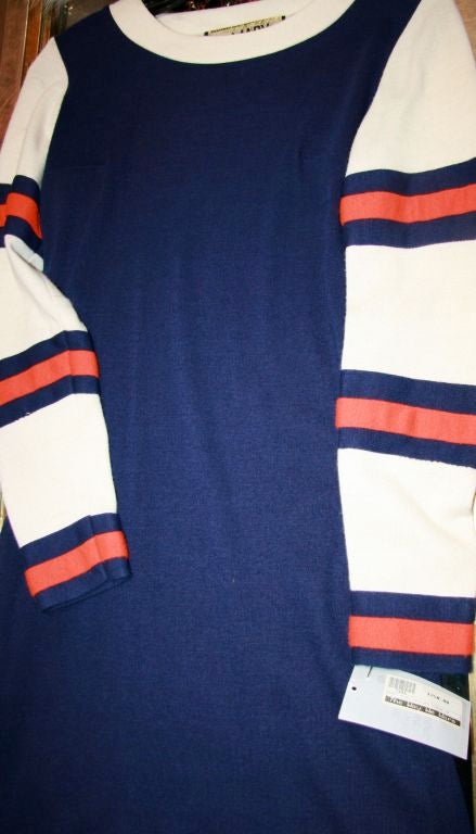 Navy Blue wool 1960s mini with full sleeves, off white with navy and orange applique stripes. Off white collar.  <br />
Bust - 34 inches<br />
Waist - 28 inches<br />
Hip - 34 inches<br />
Hem - 41 inches<br />
CF to hem - 31 inches<br