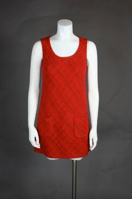 Red tweed with silver specks. A line dress with two front pockets. Jacket with unfinished edge and 4 pockets.

Additional Measurements for Jacket
Bust: 38 inches
Waist: 35 inches
CF to Hem: 22 inches
Shoulder to Shoulder: 17.5 inches